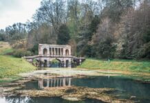 a large building sitting on top of a lush green field